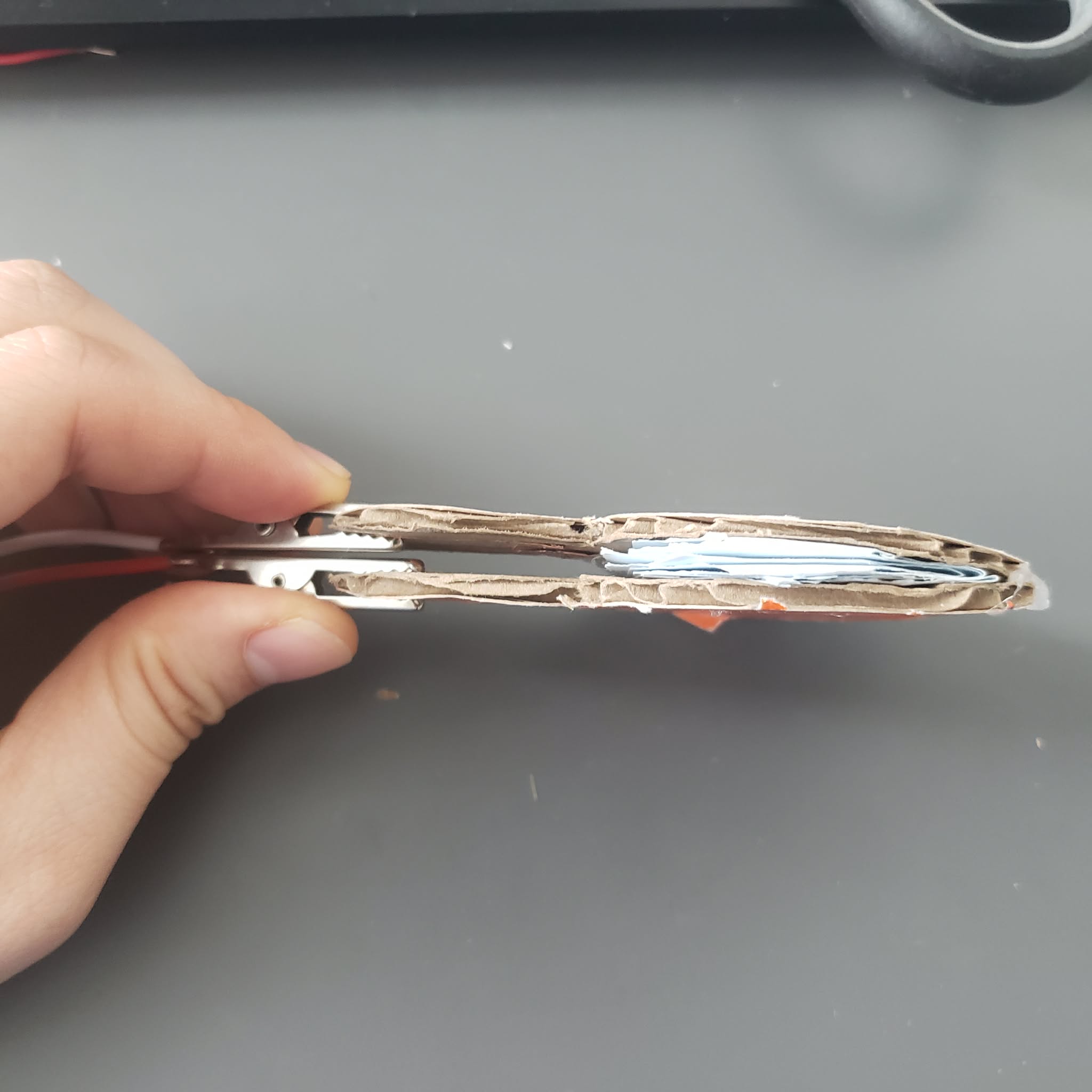 This is a prototype of a Bellows when it is activated. You are supposed to push it down to make the 2 alligator clips to touch, completing the circuit.
