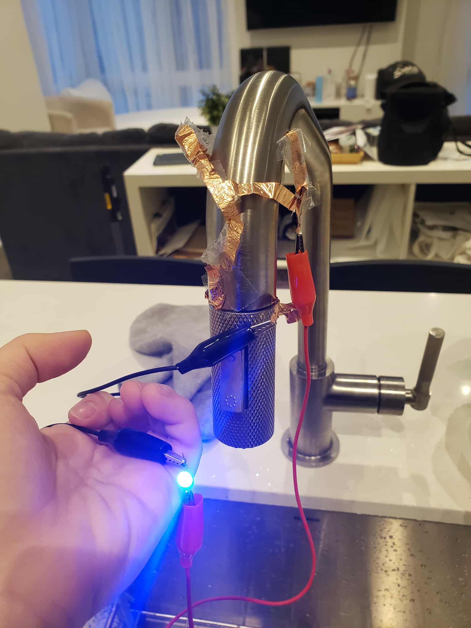 A turned on circuit using the faucet's ability to extend. The circuit is connected by returning the faucet to its original state