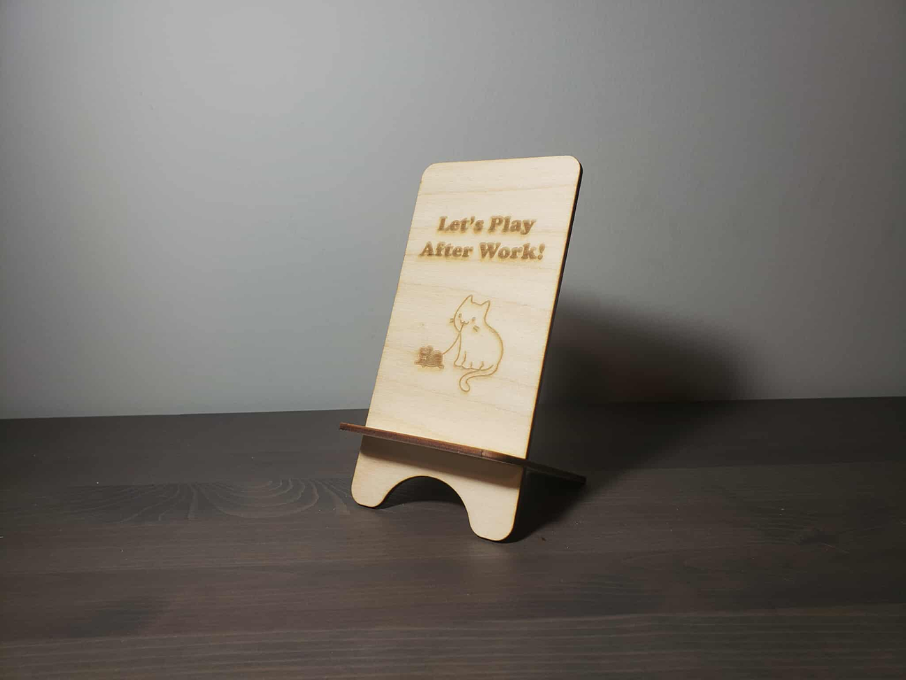 Different views of the wooden phone holder.